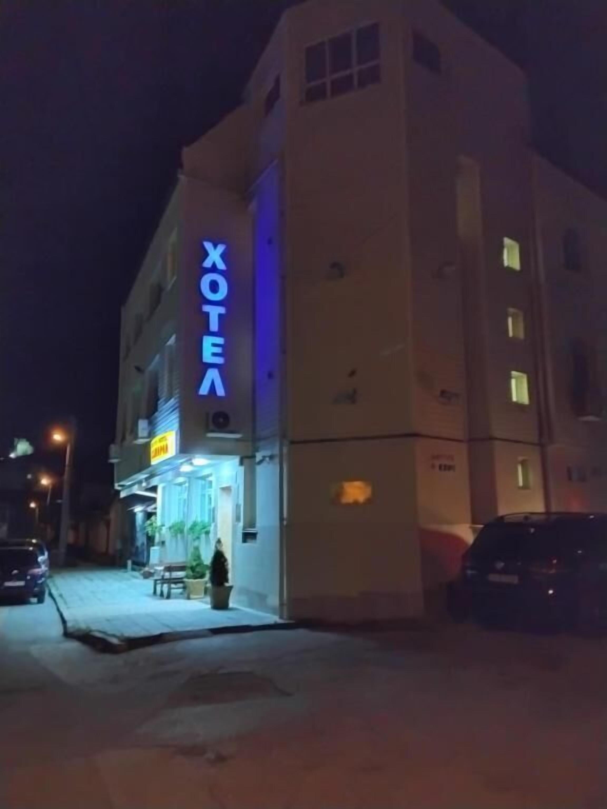 A hotel with a prominent sign reading 'XOTEA' on the facade.