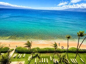 A beach with clear turquoise water, palm trees, and lounge chairs. - Mahana | 2 Oceanfront Villas, Sleeps 6 | Car Incl. w/ 6+ Nights | ML-4205 by KBM (Lahaina)