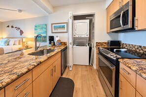 A compact kitchen with a built-in oven, microwave, and a dishwasher. - Mahana | 3 Oceanfront Villas, Sleeps 10 | Car Incl. w/ 6+ Nights | ML-4208 by KBM (Lahaina)