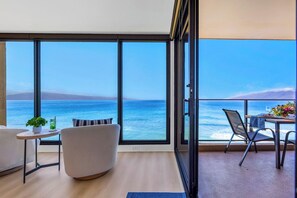 A balcony with a view of the sea, a dining table with chairs, a sofa, and a small table with a plant and drink. - Mahana | 4 Oceanfront Villas, Sleeps 14 | Car Incl. w/ 6+ Nights | ML-4211 by KBM (Lahaina)