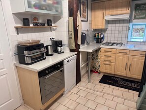 A compact kitchen with a dishwasher, a coffee maker, and a stove. - Mountain home, perfect for families (Aste-Béon)