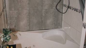 Un baño con bañera, lavamanos y ducha.