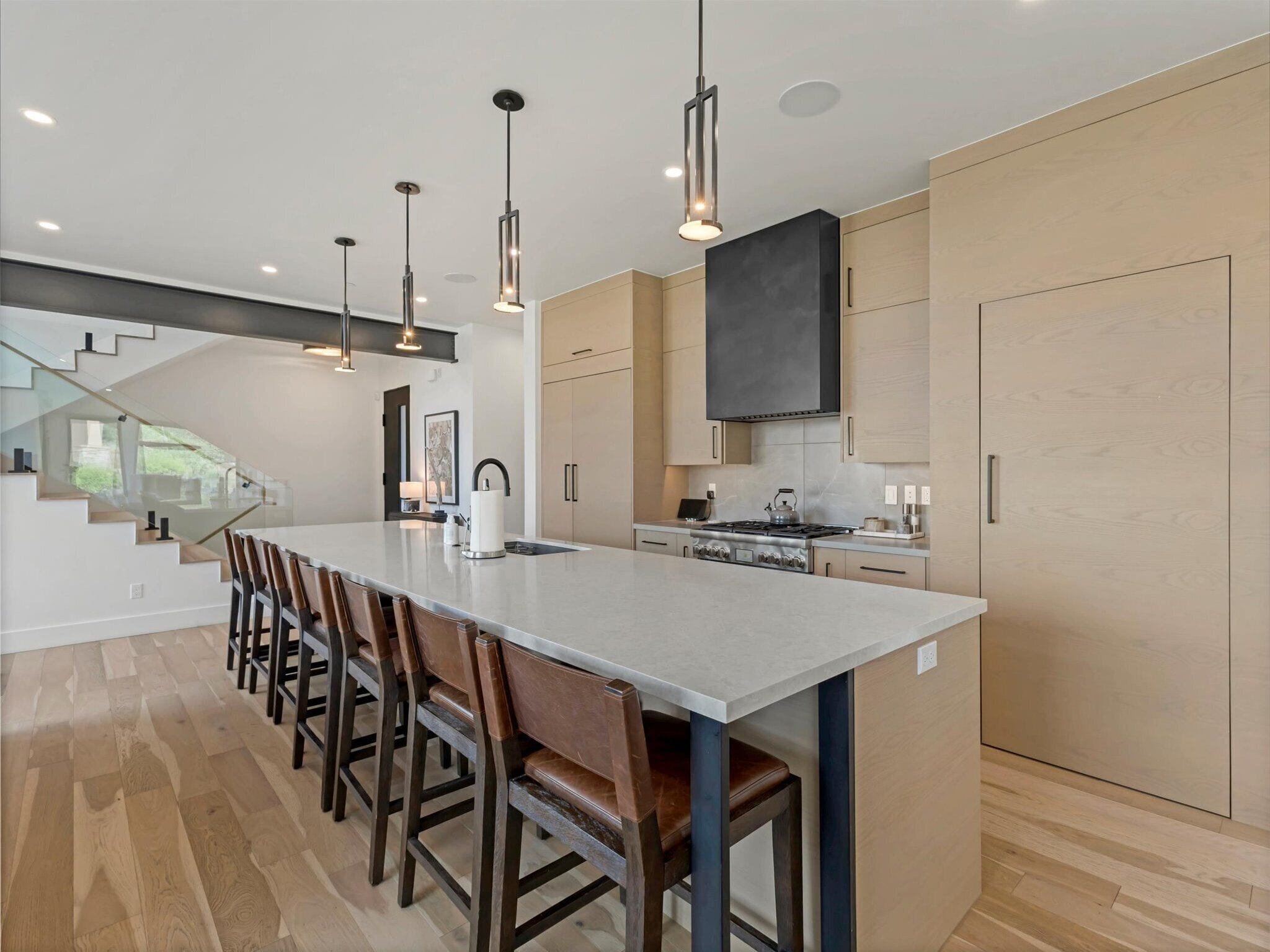 A modern kitchen with a central island, stainless steel appliances, and a sleek design.