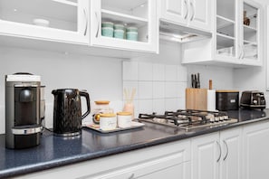 Featuring high-end appliances and a dedicated coffee station, this space has everything you need to whip up breakfast or enjoy a quiet warm brew. - Classic Australian Charm (East Victoria Park)