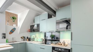 A modern kitchen with a built-in Bosch microwave, a coffee machine, and a toaster.