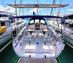 A boat deck with a steering wheel, control panel, and 'ZUBATAC' label. - Bavaria Cruiser 41 - Zubatac (Dalmacija Marina)