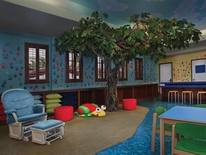 A children's playroom with a tree, colorful handprints on walls, and a blue carpet. - 3 Bedroom Villa at Lakeshore Reserve w/ Amenities (Orlando)