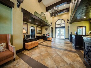 A spacious lobby with a reception desk, seating area, and a large arched doorway. - Marriott's Frenchman's Cove 2 Bedroom Villa (St Thomas)