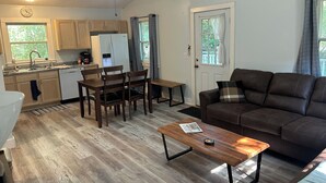 A compact living space with a kitchenette, dining area, and seating area. - Cozy 2-bedroom house in tranquil Put-in-Bay with AC (Put-in-Bay)