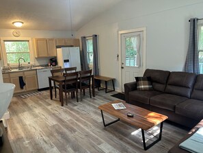 A compact living space with a kitchenette, dining area, and seating area. - Cozy 2-bedroom house in tranquil Put-in-Bay with AC (Put-in-Bay)
