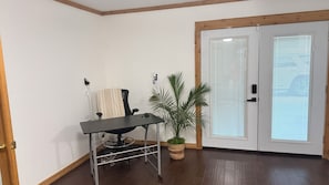 A room with a desk, chair, potted plant, and a door with frosted glass panels. - 3-bedroom house in beautiful Spring with amazing Pool (Spring)