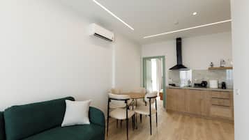 Deluxe Apartment, Balcony, Sea View | Living area | 40-cm flat-screen TV with cable channels