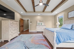 A bedroom with a bed, dresser, and a ceiling fan. - Wanderers Haven - pool + media room, gatherings (Belton)