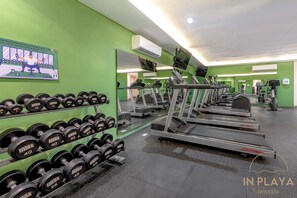 A gym with treadmills, dumbbells, and exercise machines. - Quiet Pool-View 1BR Near 5th Avenue (Playa del Carmen)