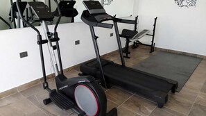 A gym with cardio equipment including a ProForm Sport 6.0 elliptical, a treadmill, and a stationary bike. - Quiet Studio w Rooftop Pool near DAC Market (Playa del Carmen)