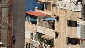 A coastal urban area with buildings adjacent to the sea, featuring balconies and visible sea views. - One Minute To The Sea-Asafra Beach 
Fast WiFi - AC - Family Friendly (Alexandria Governorate)