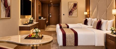 A hotel room with a bed, bedside table, and a seating area with a table and chairs.