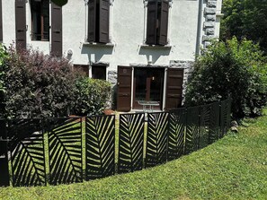 A building with a white facade, brown shutters, and a glass door entrance. - Studio with south terrace & Mont Blanc view (Chamonix-Mont-Blanc)