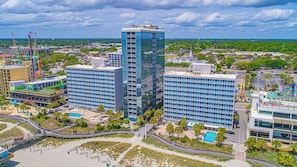 A high-rise hotel with multiple floors, a swimming pool, and a beach area. - Oceanfront Stay by Skywheel! Yachtsman 1002 (Myrtle Beach)
