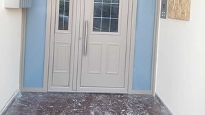 A double door entrance with a small step leading up to it.
