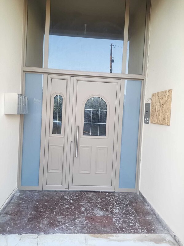 A double door entrance with a small step leading up to it.