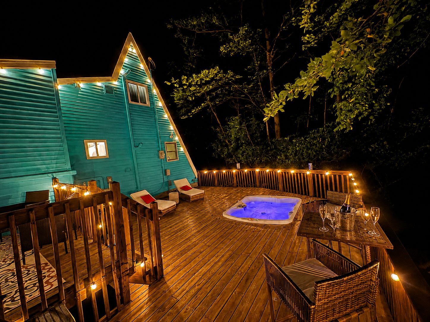 A cozy outdoor area with a hot tub, wooden deck, and lounge chairs.