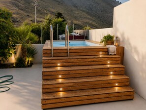 A wooden staircase leading to a pool area with a view of a hillside. - Lemon Tree House con Piscina Privata Castelluzzo (San Vito Lo Capo)