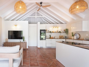 A spacious living area with a TV, wooden furniture, and a ceiling fan. - Villa Belle infinity pool and unique charm featuring 3 air-conditioned bedrooms (Grand-Bourg)