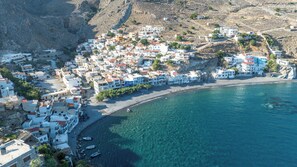 A coastal town with white buildings, a beach, and clear blue waters. - Aeriko Villa with Private pool - Where mountains meet the sea (Heraklion)