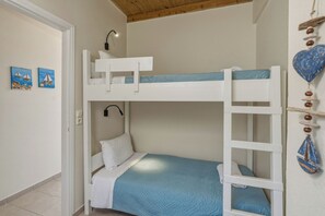 A bunk bed room with a ladder, a wall-mounted lamp, and two paintings. - Aeriko Villa with Private pool - Where mountains meet the sea (Heraklion)