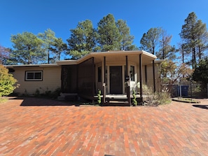 A single-story house with a covered porch, a brick driveway, and a mailbox. - Tranquil 3 BDR family friendly home. 10min to town. 20min to Pajarito Ski Hill. (Los Alamos)