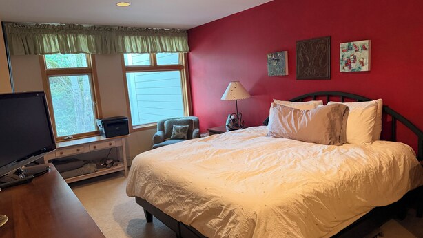 A bedroom with a bed, a desk with a computer, a chair, a lamp, and artwork on the wall. - "Frisco Mountain Retreat 3BR/3BA, Sleeps 7 — Steps from Slopes & Summer Trails" (Frisco)