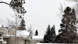 A residential area with multiple houses, a staircase leading to a deck, and snow-covered roofs. - "Frisco Mountain Retreat 3BR/3BA, Sleeps 7 — Steps from Slopes & Summer Trails" (Frisco)
