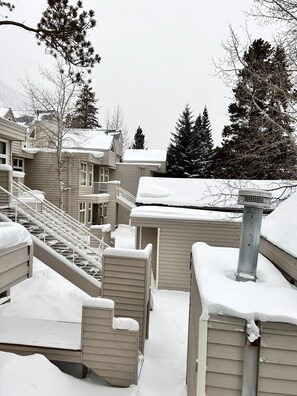 A residential area with multiple houses, a staircase leading to a deck, and snow-covered roofs. - "Frisco Mountain Retreat 3BR/3BA, Sleeps 7 — Steps from Slopes & Summer Trails" (Frisco)