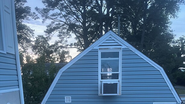 A blue shed with a white door and windows, a small porch, and a sign indicating it's open. - The Dutchmen 420 Friendly. Loft tiny house  (Ocean View)