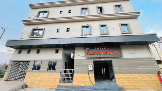 A multi-story hotel with a prominent entrance and a sign reading 'HOTEL KESARI NANDAH.'