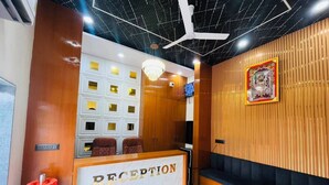 A reception area with a reception desk, seating, and a television.
