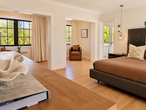 A bedroom with a bed, a nightstand, a chair, and a desk with a book. - Hideaway & Harbour -2 minute walk to the beach (Fort Lauderdale)
