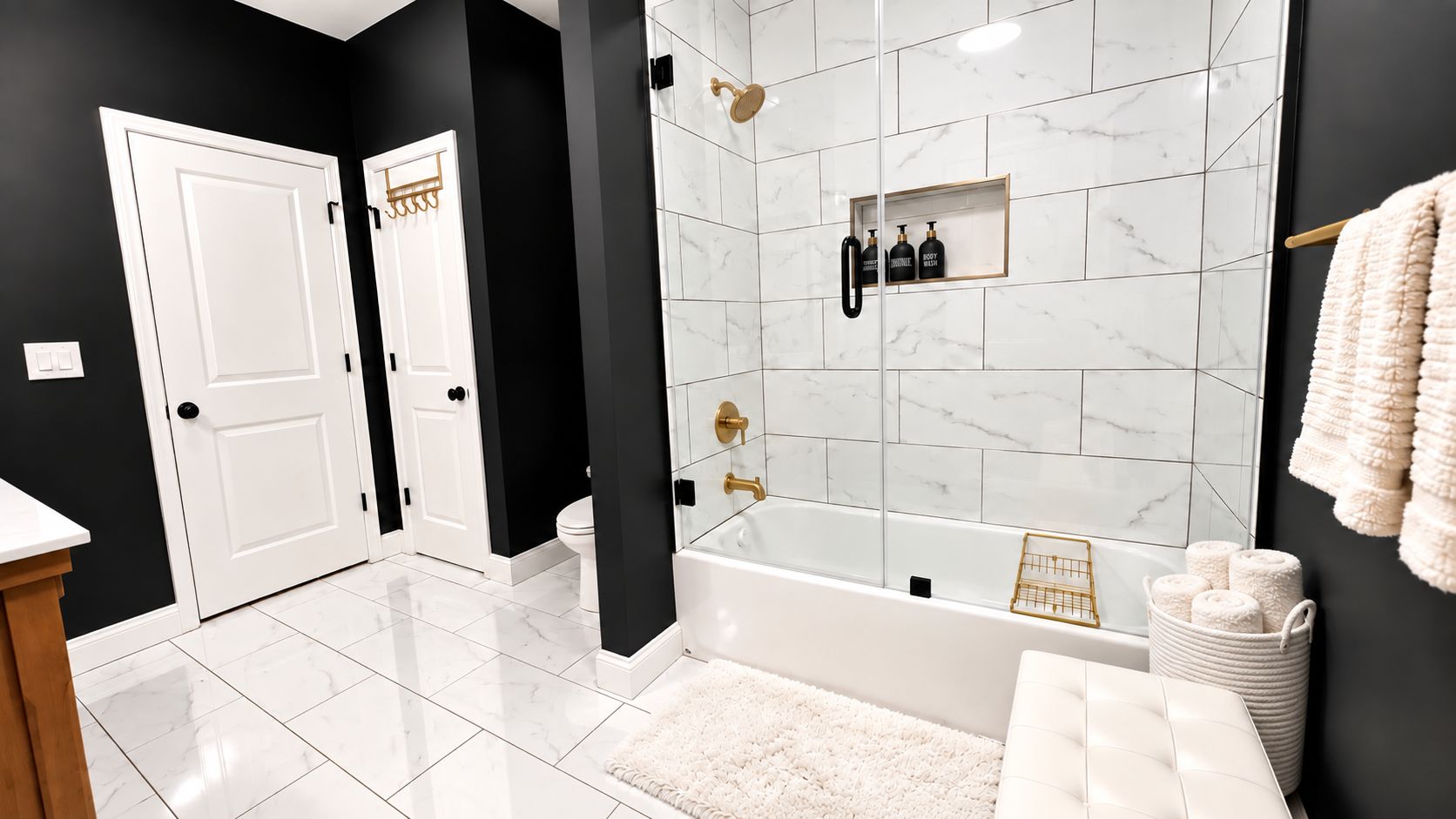 A modern bathroom with a bathtub, a shower, and a toilet. There are towels and toiletries on the wall.