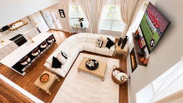 A modern living space with a kitchen, dining area, and seating area.