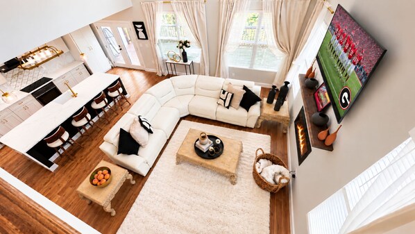 A modern living space with a kitchen, dining area, and seating area.