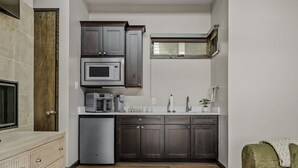 A compact kitchen with built-in appliances, a sink, and a window. - Charming Lakeside Cabin / BBQ Grill / Pickleball (Lake Travis)