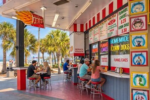 A food truck with a menu board advertising funnel cakes and corn dogs. - Myrtle Blue Retreat 1BR Oceanfront Yachtsman 905 (Myrtle Beach)