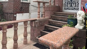 A brick building with a metal gate, a stone bench, and a statue. - Spacious Brooklyn 4BR/2BA Across 2 Private Floors with Yard (Brooklyn)