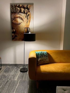 A room with a yellow sofa, a black floor lamp, and a wall-mounted artwork. - Spacious 3-bedroom apartment in beautiful Cancún with AC, Gym and rooftop Pool (Cancún)