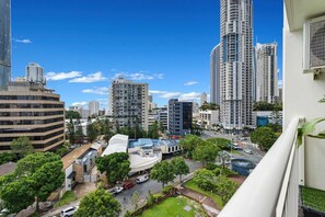 A high-rise urban area with modern buildings, a clear sky, and a mix of greenery and paved areas. - Central 2B Apartment Parking. Wi-Fi. Views. (Surfers Paradise)