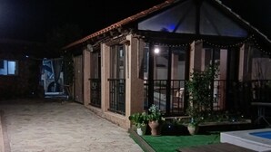 A stone-paved courtyard with a covered seating area, potted plants, and a pool. - Rural House 8 km from Cuenca (World Heritage Site) (Villar de Olalla)