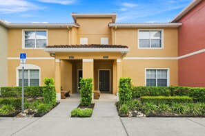 A two-story building with a flat roof, numbered 3085 and 3083, featuring a front entrance with a door and a small porch. - Free Pool Heat | Hypoallergenic Private Villa | Lux Resort (Four Corners)