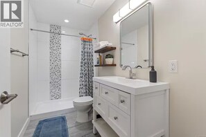 Shower, towels, soap, toilet paper - Seaside One Bedroom Suite with Parking (Colwood)