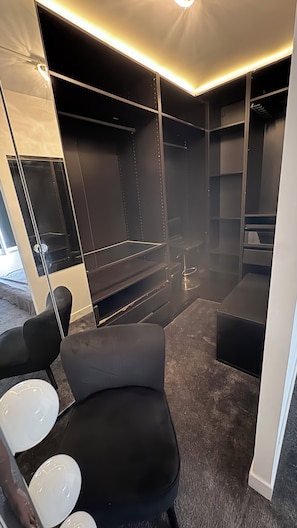 Et moderne badeværelse med et sort badekar, en glas brusekabine og en vaskepult med et spejl.